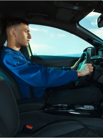 Homme conduisant la PEUGEOT E-208